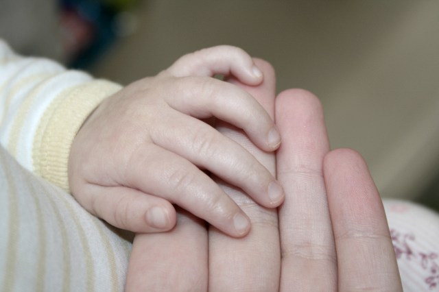 Baby holding hands